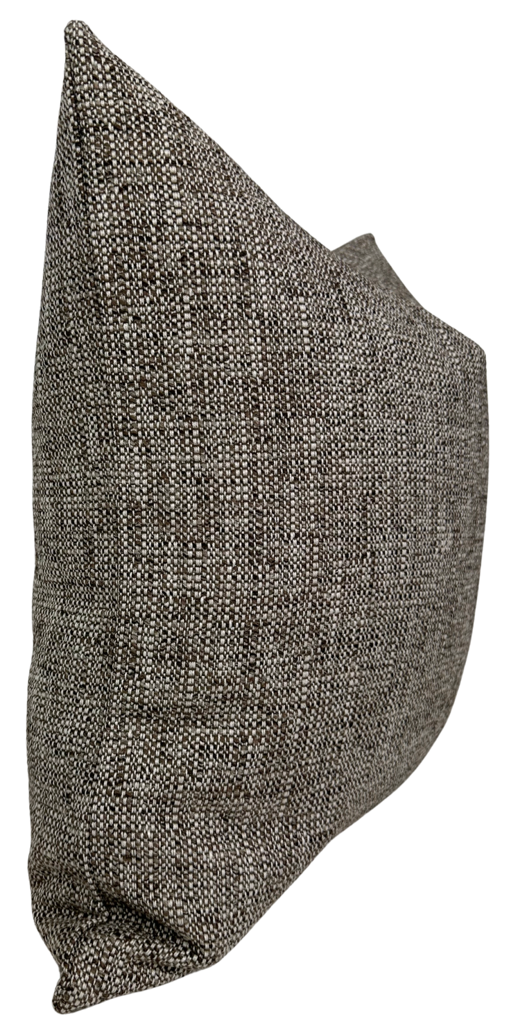 Rectangular pillow cover in a textured chestnut-colored fabric with a mix of brown and beige fibers, shown from a slightly angled side view.