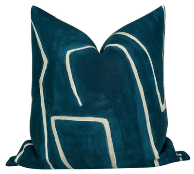 Graffito Pillow Cover in Teal Pearl displayed on couch with teal abstract pattern and ivory linen backside
