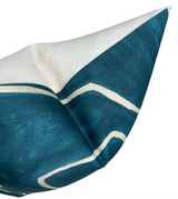 Close-up of a Graffito Pillow Cover with a teal pearl background and irregular white linear graffiti-like patterns on textured fabric.