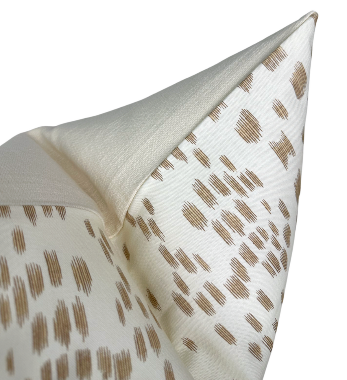 Close-up of Les Touches pillow cover in sand color with a creamy background and overlapping brushstroke pattern in soft brown tones.