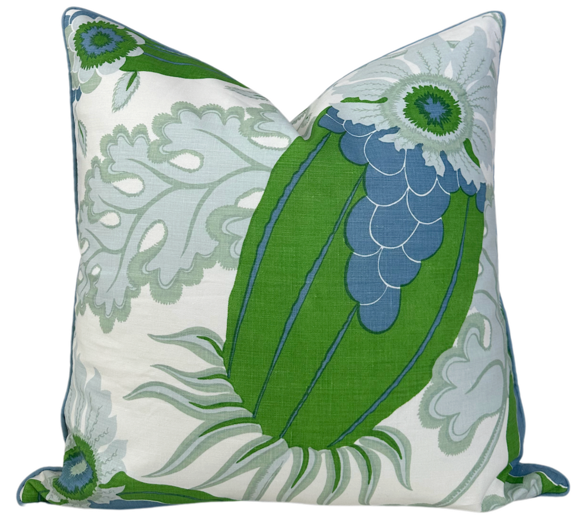 Square pillow cover featuring a large green and blue floral design with pale gray leafy patterns on a white background, folded gently at the corners.