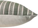 Close-up of a pillow cover with green and natural beige woven stripes on the top and solid natural beige fabric on the side, featuring a small zipper.