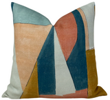 Square pillow cover featuring abstract geometric shapes in apricot, teal, sandstone, mustard, and cream on textured fabric