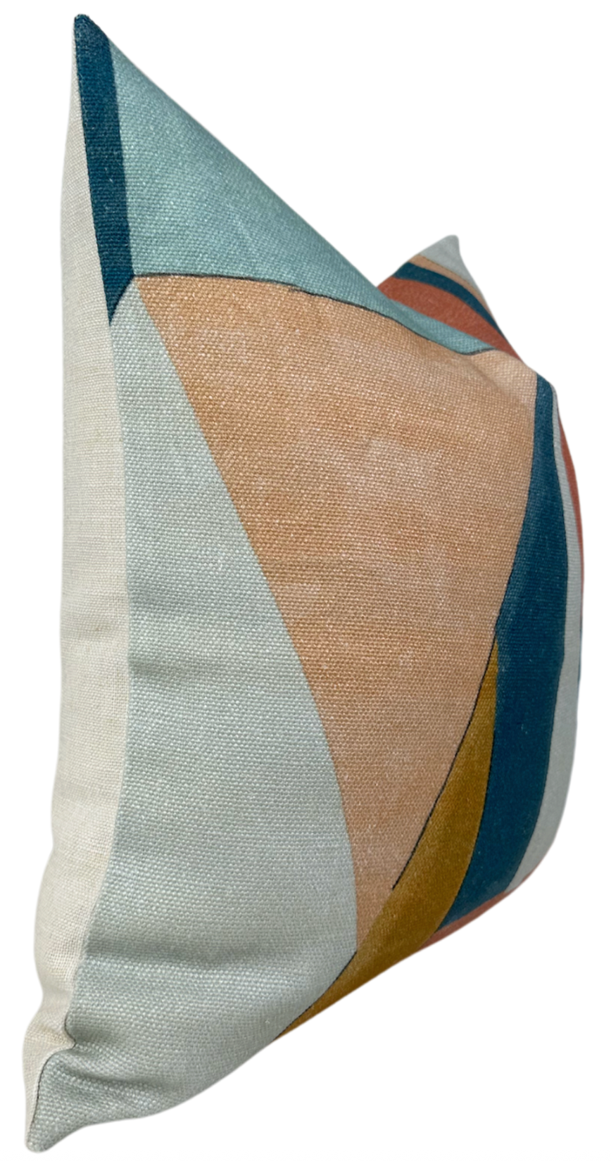 Pillow cover with abstract geometric design in apricot, teal, mustard, and blue shapes on a textured fabric background.