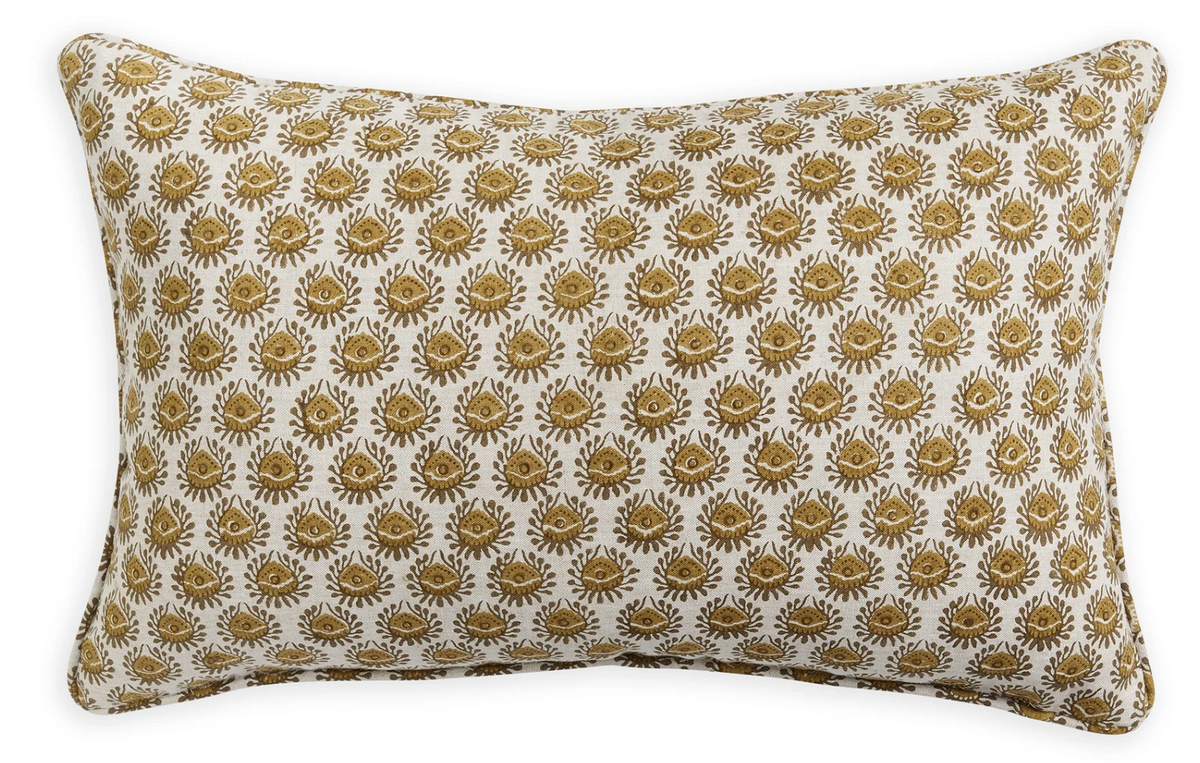 Rectangular pillow with a repeating saffron-colored floral and sunburst pattern on a white background, featuring matching piped edges.