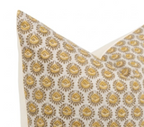 Square pillow with a cream background and repeating saffron yellow floral pattern, shown from a close-up front angle highlighting the design detail.