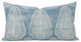 Rectangular lake blue pillow cover with white distressed geometric patterns in three large motifs across the front.