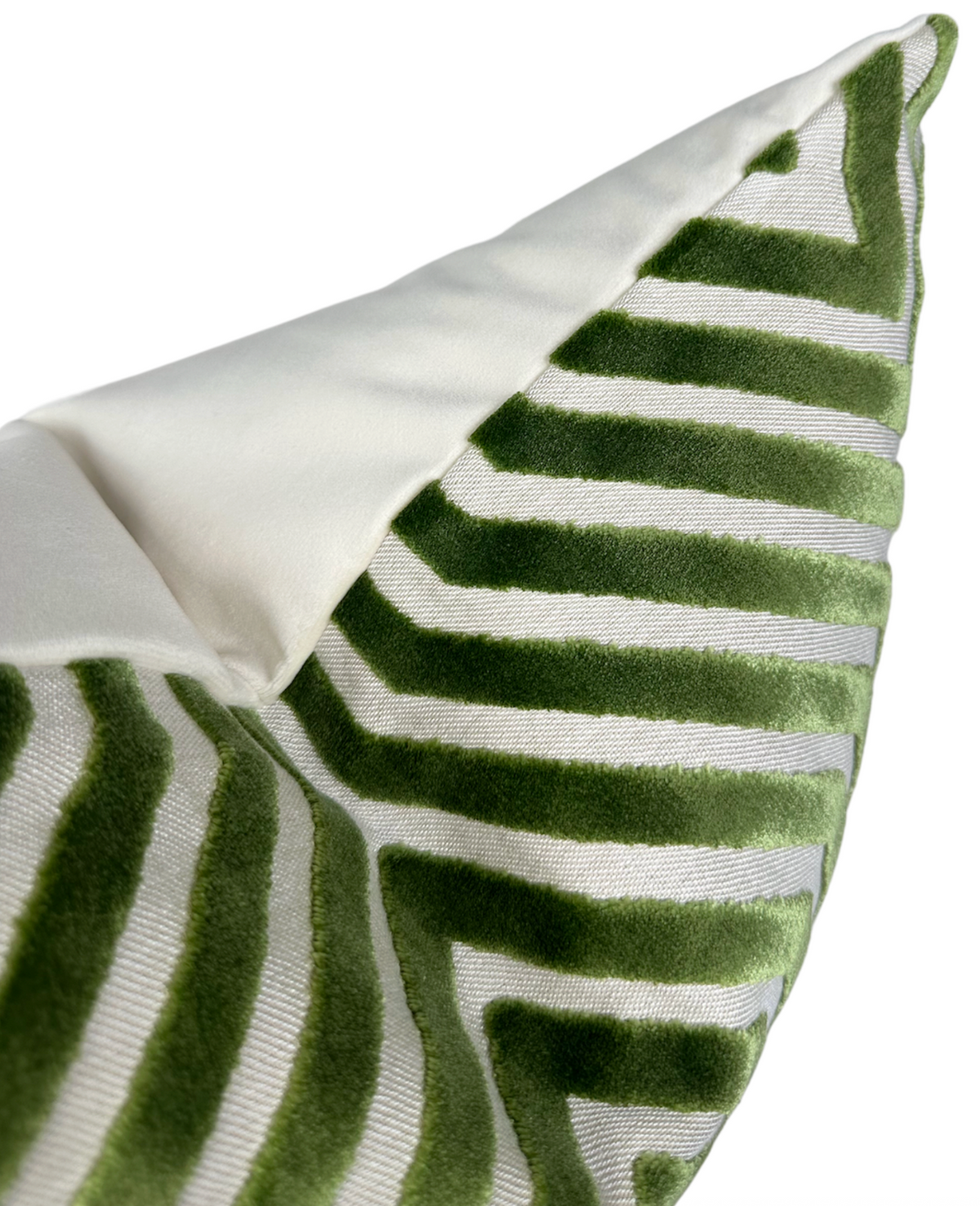 Lettuce green velvet stripes forming a geometric chevron pattern on white fabric, shown on a folded pillow corner with a plain white reverse side.