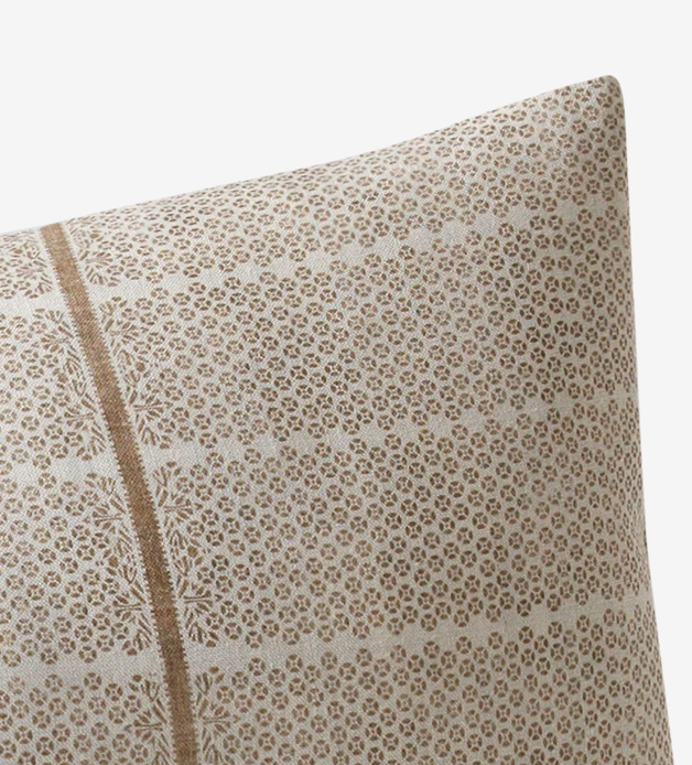Close-up of sand brown Madu Pillow Cover with delicate repeating floral pattern and a vertical stripe detail by Susan Connor Textiles.