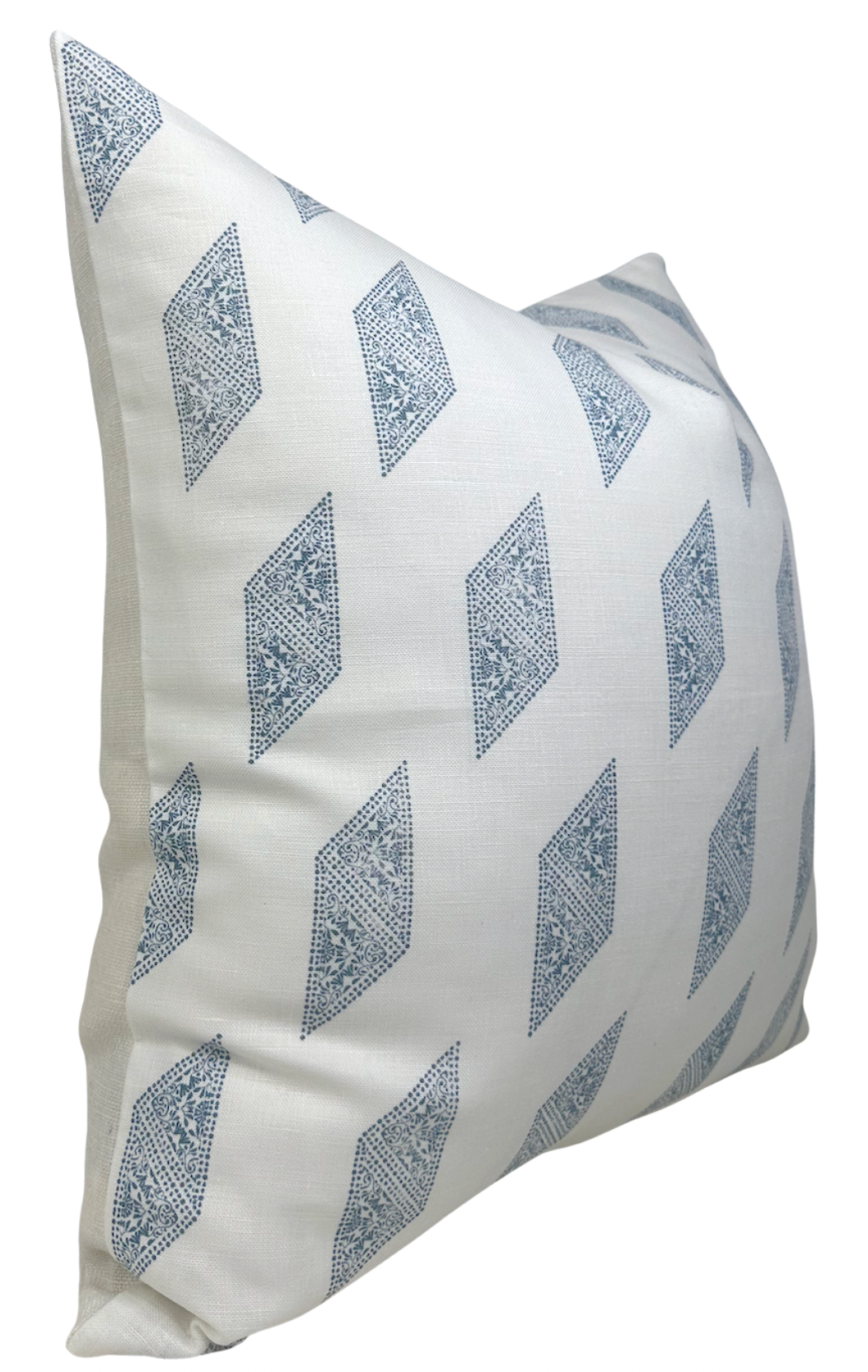 Square pillow cover in off-white fabric patterned with repeated blue geometric diamond shapes arranged diagonally.