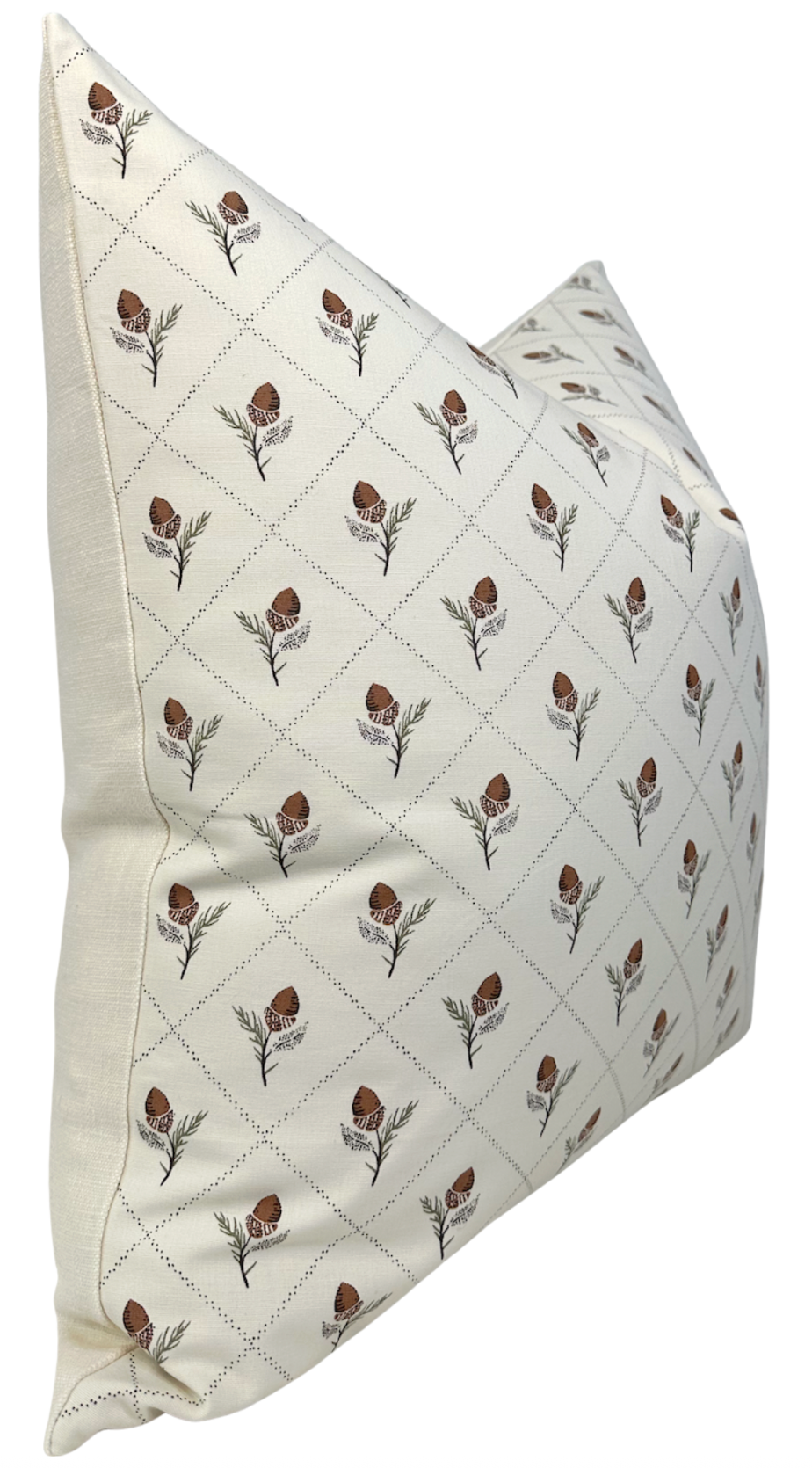 Cream-colored pillow cover patterned with small brown floral motifs arranged diagonally in a grid on a soft fabric.