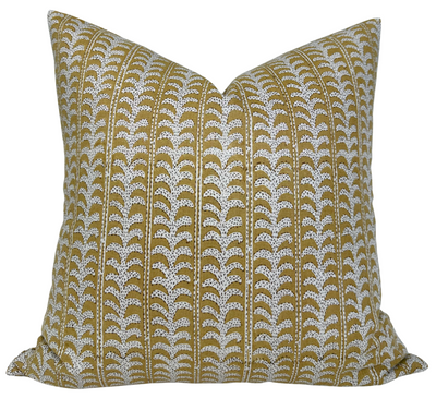 Luxor Pillow Cover in Saffron with ivory linen backing displayed on a wooden chair