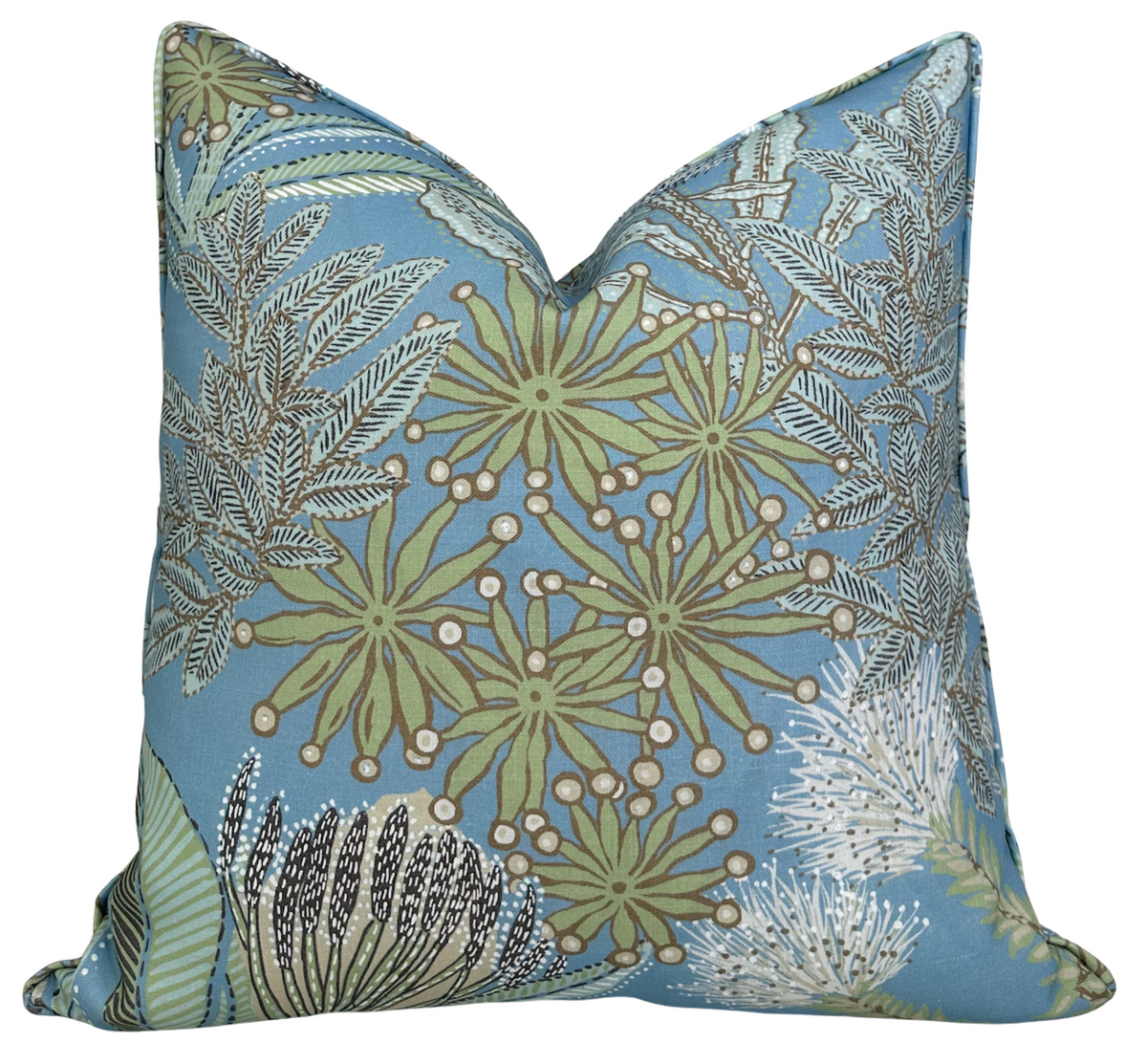 Square pillow cover with spa blue background featuring botanical prints of green protea flowers and detailed fern leaves in white and black outlines.