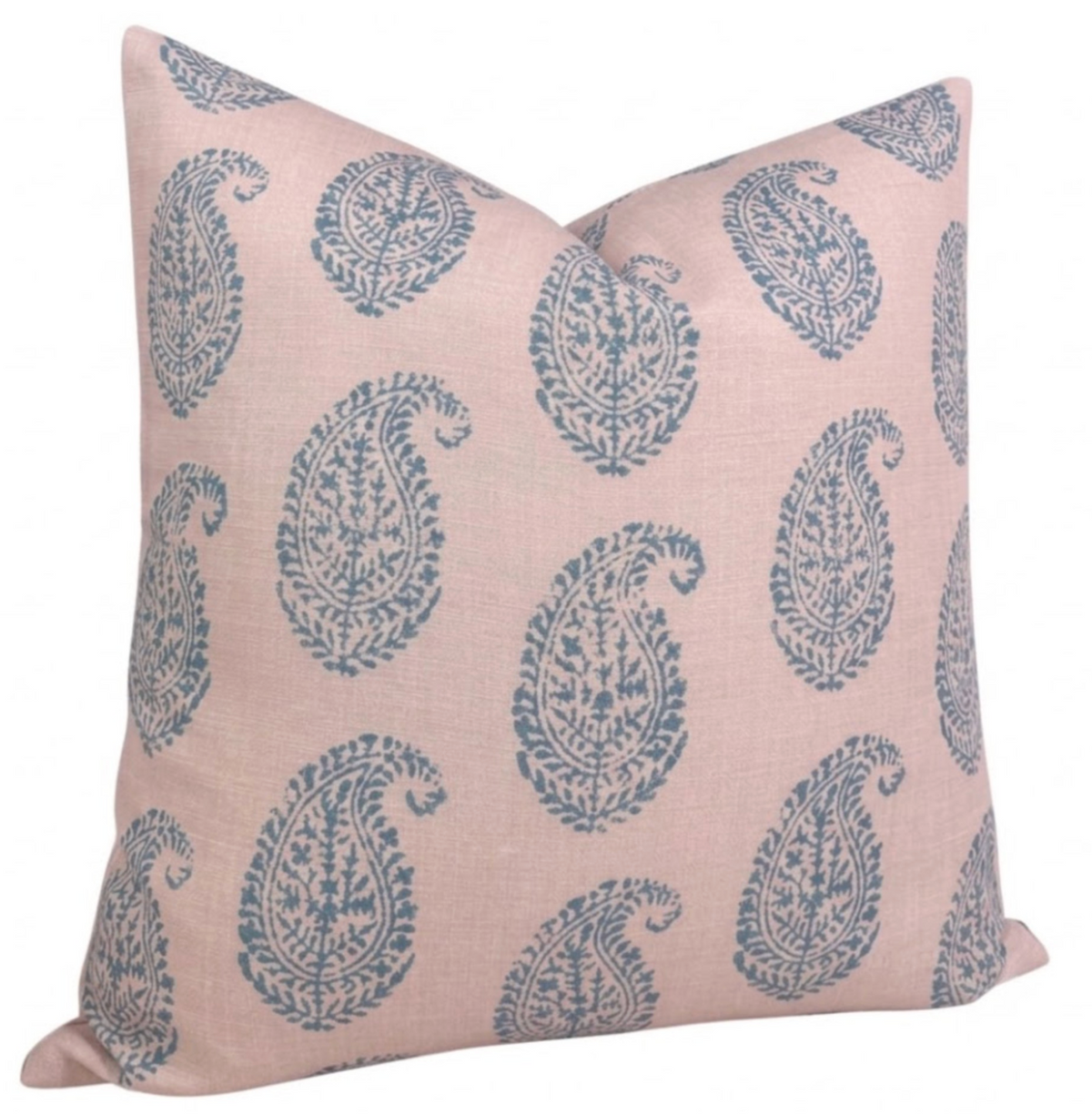 Square pink pillow cover patterned with evenly spaced blue paisley motifs, displayed with a slightly slanted front view.