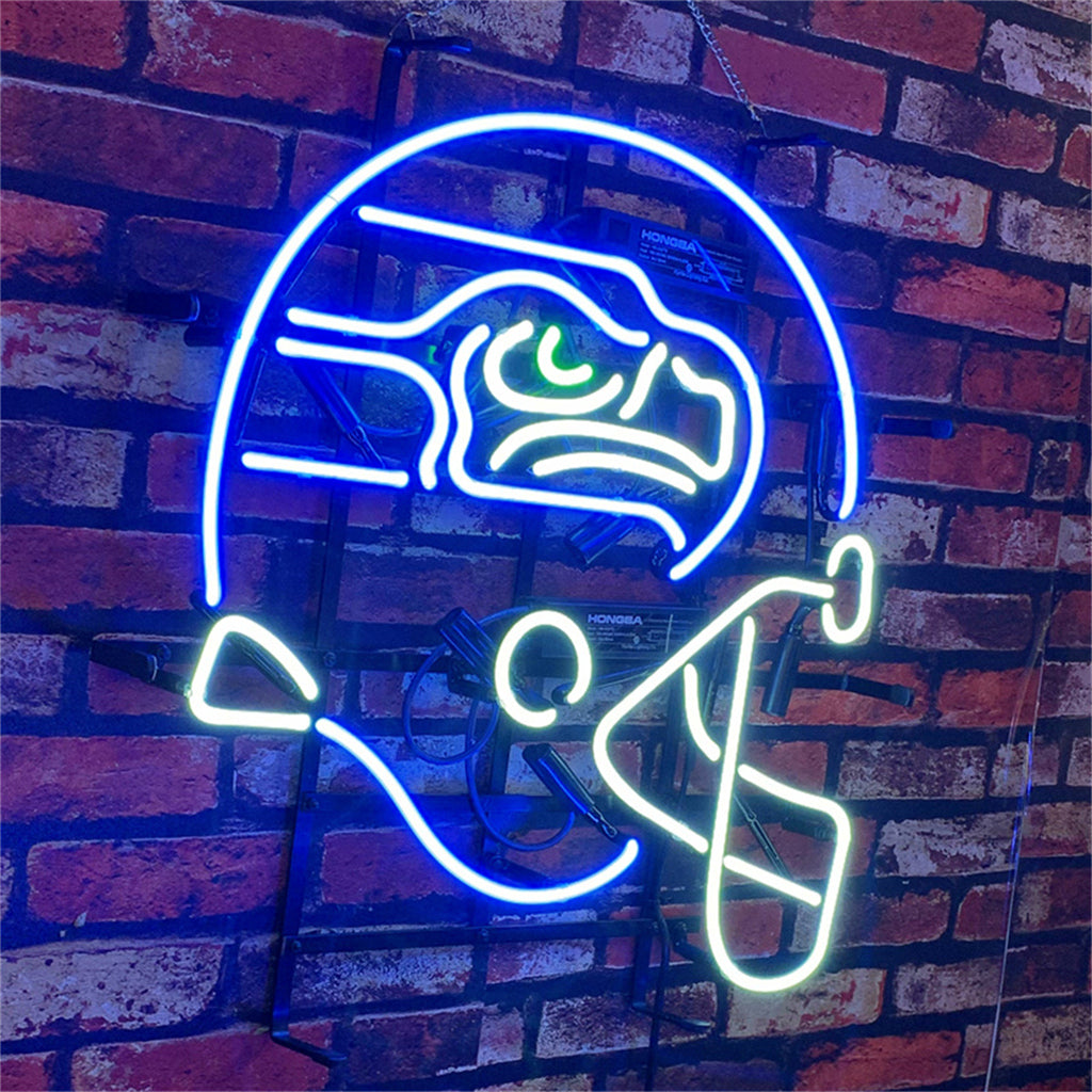 Neon sign of a Seattle Seahawks football helmet in bright blue, white, and green lights mounted on a red brick wall.