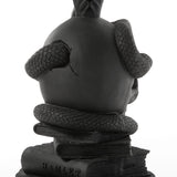 Black sculpted skull with textured snake wrapped around it, resting on two stacked books, one titled 'Hamlet', all in matte black finish.