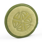 Round cushion designed like a sliced cucumber with light green center and darker green outer edge, featuring six seed patterns in the middle.