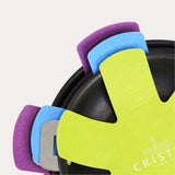 Set of three colorful pan protectors in purple, blue, and yellow with scalloped edges, stacked partially visible inside a black pan.