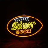 Neon sign in orange, yellow, and white lights shaped like a football with the text 'Shiner Bock' inside