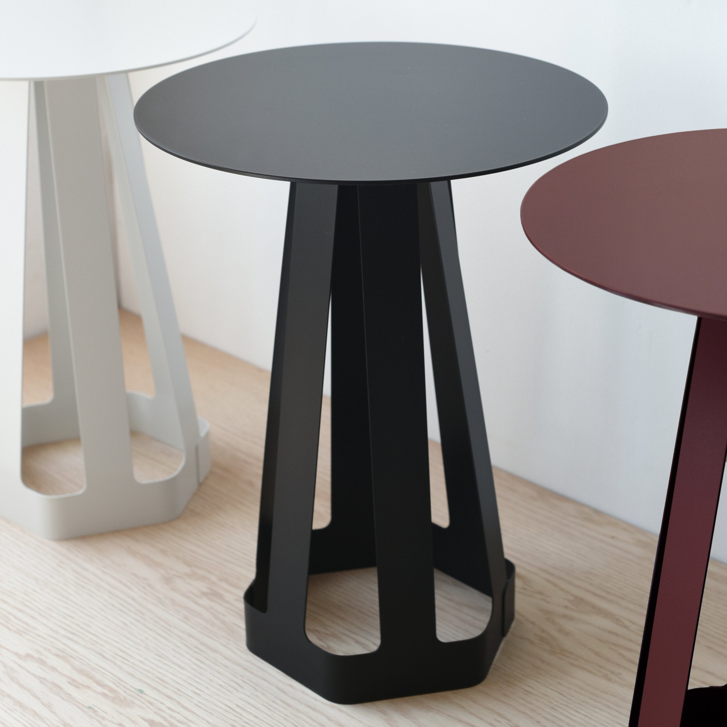 Misewell Sixagon compact side table in Ox Blood color, shown with detail shots and white and black variants