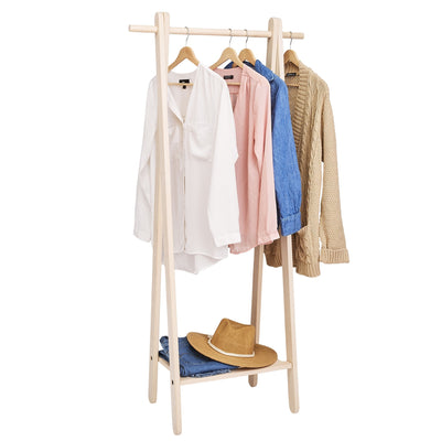Handcrafted wooden garment rack holding clothes and coats in a home setting