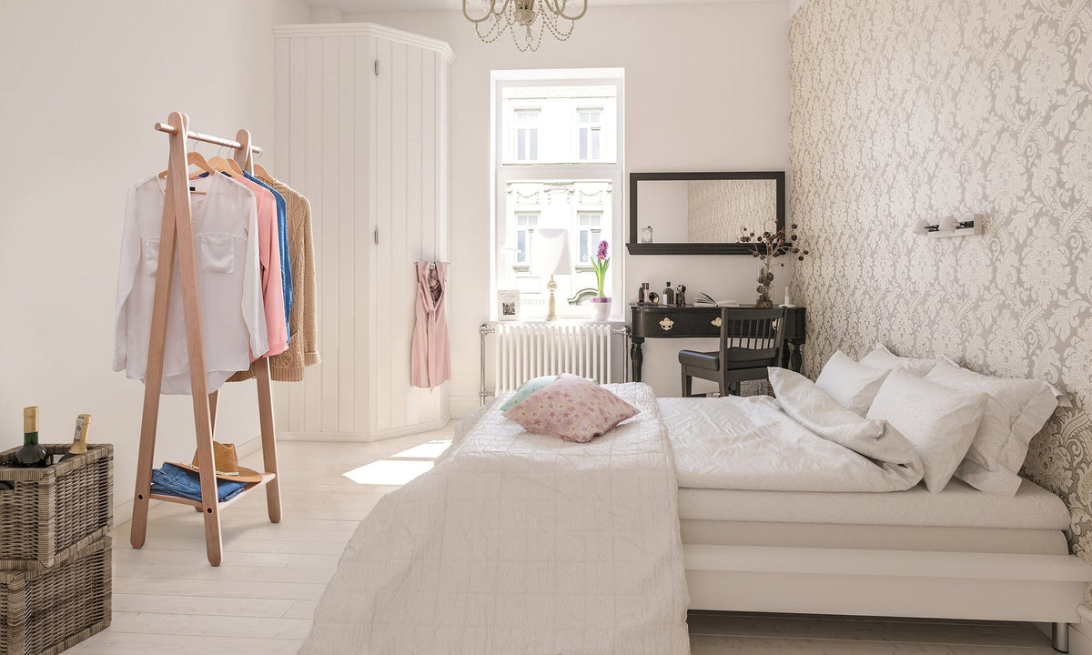 Handcrafted wooden garment rack holding clothes and coats in a home setting