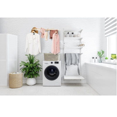 Fold down wall mounted clothes drying rack made of maple hardwood with clothes drying on it