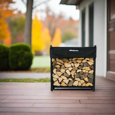 Woodhaven 3 ft Firewood Rack with seasoning cover in black finish holding stacked firewood