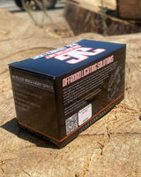 Black rectangular box labeled offroad lighting solutions and RLS LED rock light specs, set on a textured outdoor stone surface in natural light.
