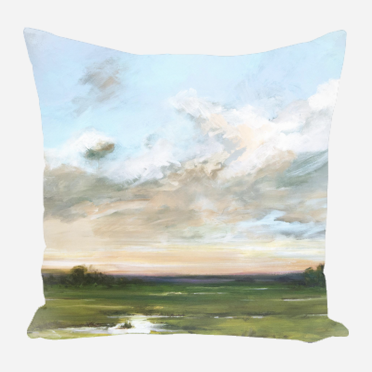 Square pillow featuring a painted landscape with a vast green field and dramatic cloudy sky at sunset on a light background