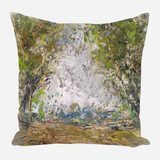 Abstract impressionist pillow with textured brushstrokes in earthy greens, browns, and light blues depicting a forest clearing or pathway scene.