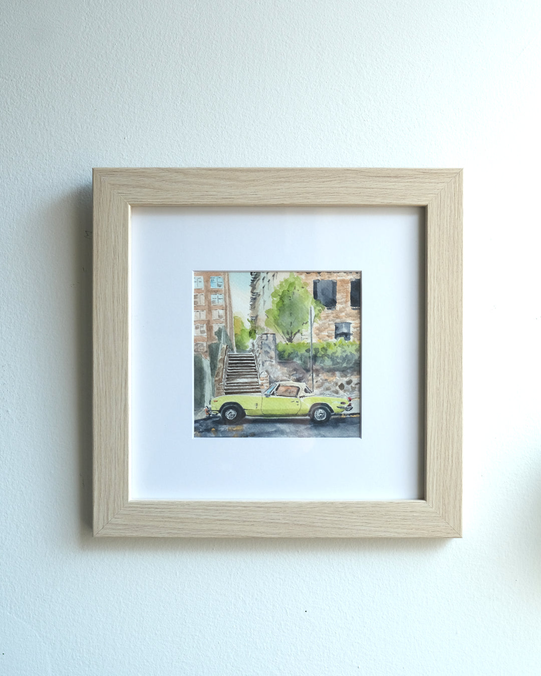 Watercolor painting of Triumph Spitfire MK3 car parked on Cabrini street, NYC