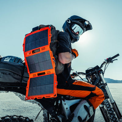 Spectre 18W Solar Panel in Orange with visible ports and kickstand