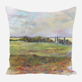 Square pillow featuring an impressionist-style landscape with green fields, distant trees, and a cloudy sky with blue and beige tones.
