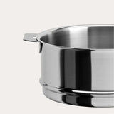 Close-up side view of a polished stainless steel steamer insert with a flat handle against a plain light background