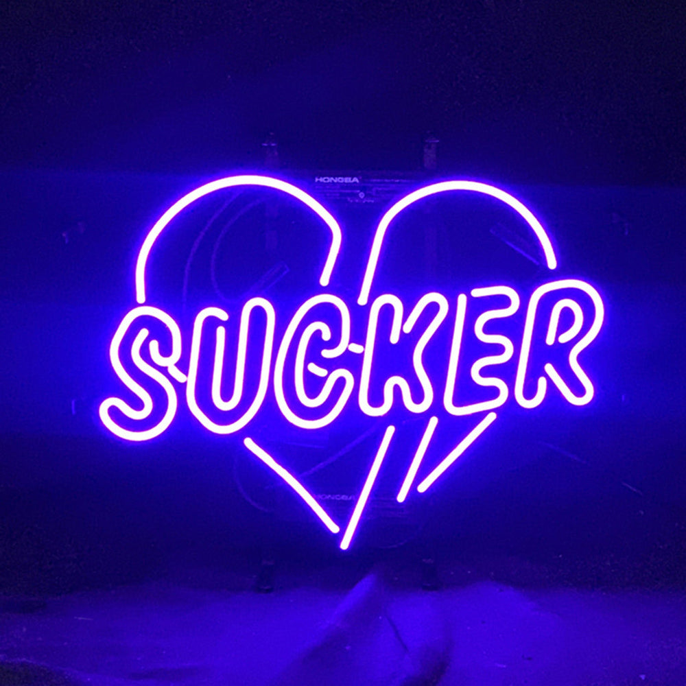 Sucker Heart Neon Sign with glowing red heart shape on metal grid backing