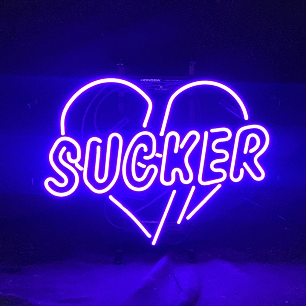 Sucker Heart Neon Sign with glowing red heart shape on metal grid backing