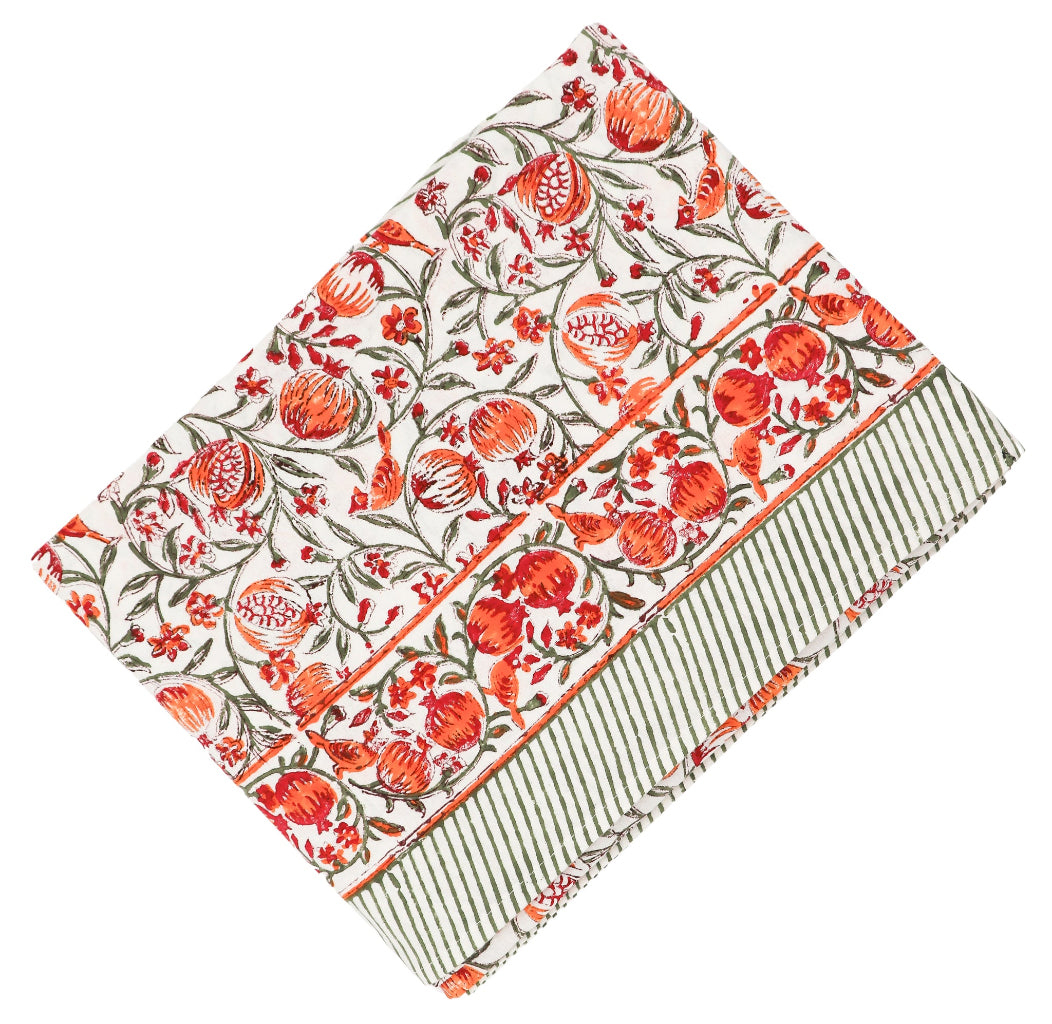 Sunset Orchard Tablecloth featuring hand-printed pomegranate design in orange, maroon, and green on white cotton