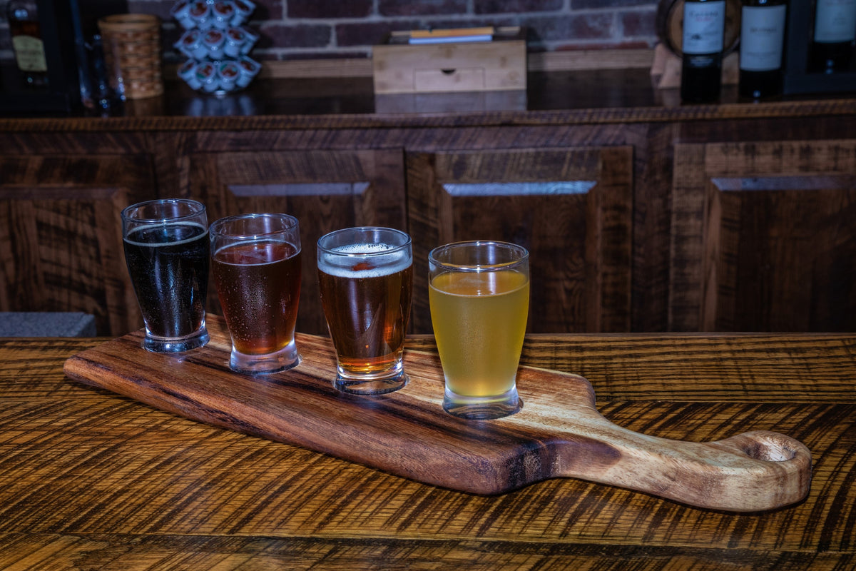 Medium live edge handled bread board made from East Indian Walnut on tabletop