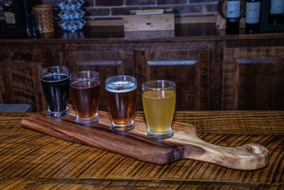 Medium live edge handled bread board made from East Indian Walnut on tabletop