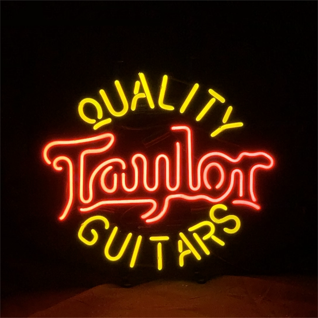 Taylor Quality Guitars Neon Sign Light glowing with a blue neon in a dark room setting