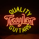 Neon sign displaying 'Quality Taylor Guitars' with 'Taylor' in red script and the other words in yellow block letters on a black background.