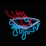 Eye Tear Neon Light Sign lit in pink against a white wall