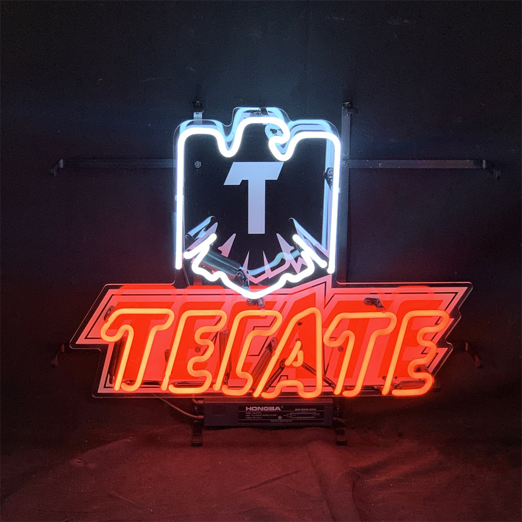 Tecate Lager Beer Neon Light Sign in dark room emitting warm neon glow