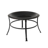 Black round metal fire pit with a wide rim, supported by four outward-curving legs connected by a circular ring, featuring a grated fire area in the center.