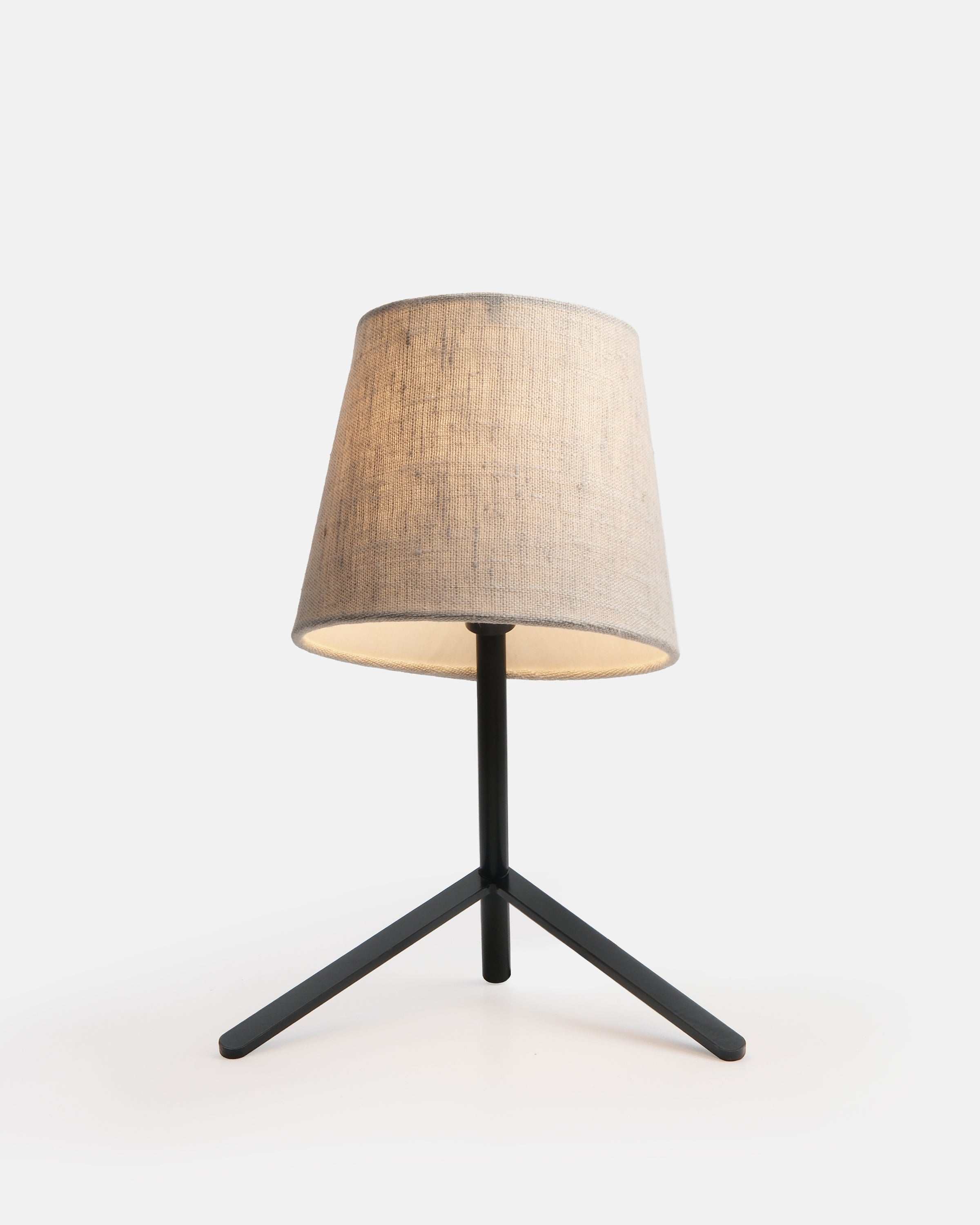 Tokyo Table Lamp in black with unbleached cotton shade on a wooden surface