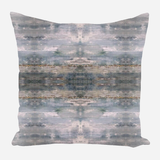 Square pillow with symmetrical abstract pattern in muted blue, gray, and beige tones resembling weathered wood or stone textures.