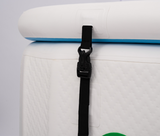 Black plastic clip and adjustable strap securing the blue and white removable headrest on a white textured inflatable tub side.