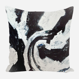 Square pillow with abstract black and white brushstroke pattern forming a swirling, dynamic design in a textured painterly style.