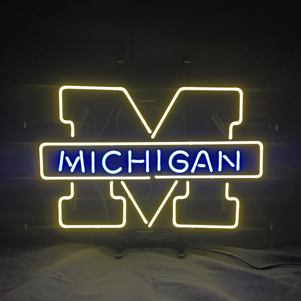 Neon sign with a large yellow outline letter M and the word 'MICHIGAN' in blue neon across the center on a dark background.